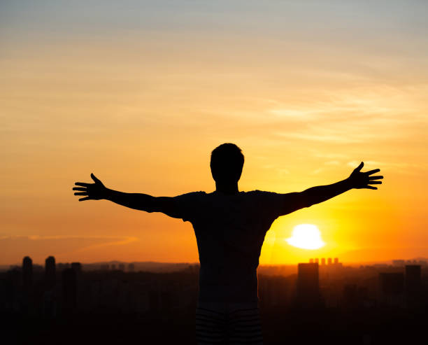 istock Man with open arms to the sunset in Sao Paulo 1446524728