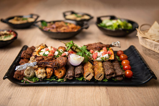 Assorted mix grills with tikka boti seekh kabab of chicken, beef, lamb, mutton bbq platter served in dish isolated on table top view of arabian food