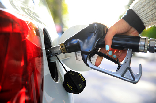 Close-up of a person refueling diesel at a petrol station