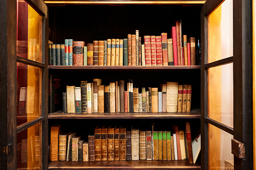 Bookcase with open glass doors, very old books