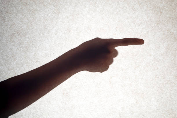 istock The shadow of a hand with an outstretched finger points to the side. 1446531740