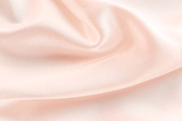 istock folds of beige silk fabric texture background 1446533358