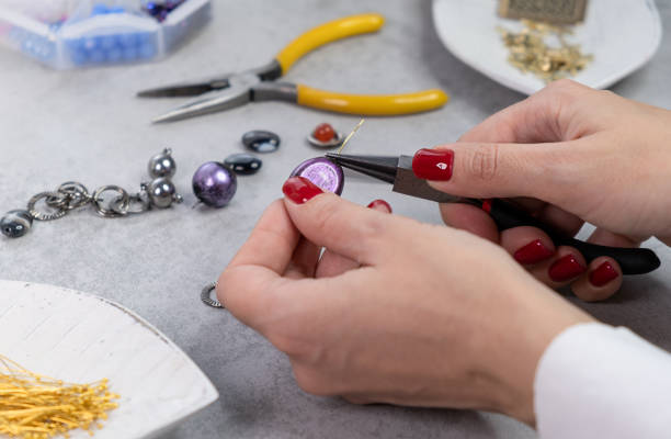 istock Female create handmade jewelry. Handmade beading preparation 1446540490