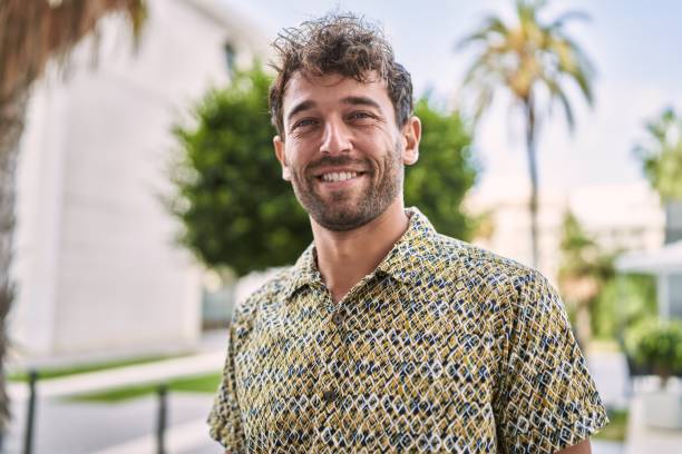 Young hispanic man smiling confident walking at street