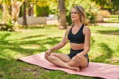 Young woman smiling confident training yoga exercise at park