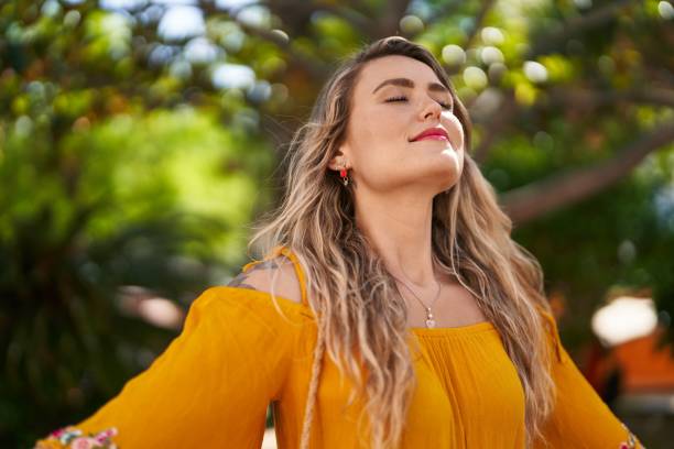 istock Young woman smiling confident breathing at park 1446543746