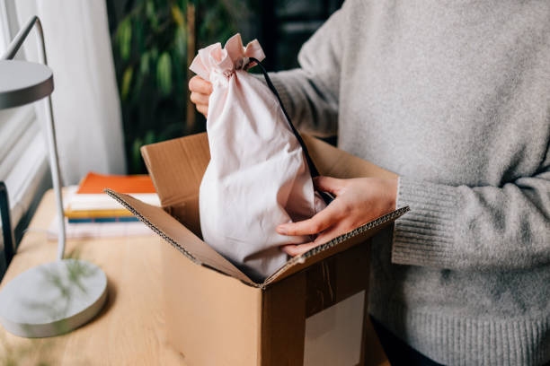 istock Woman Unpacking a Parcel She's Just Received 1446544144