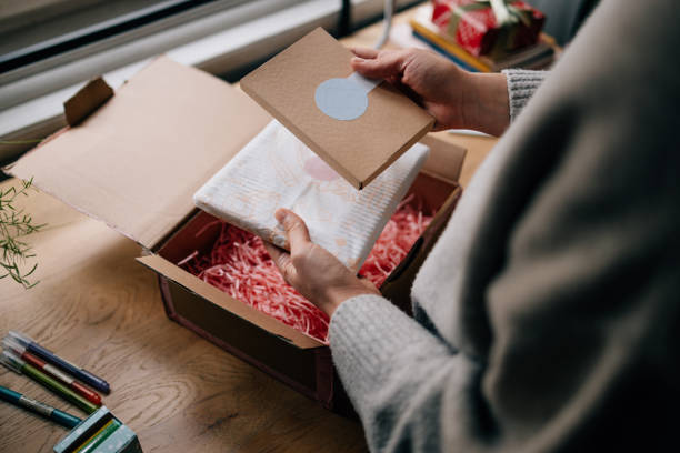 istock Woman Unpacking a Package She's Just Received 1446544162