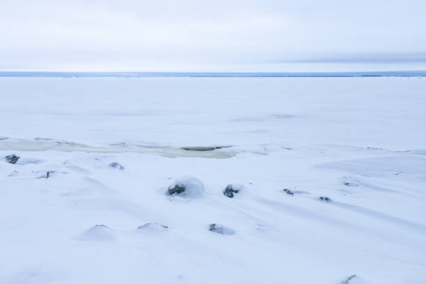 istock Winter landscape with stones and ice under white snow. 1446548297