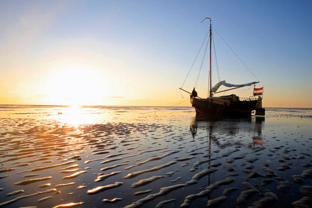 istock A sailboat lying on a sandbank during low tide 1446550942