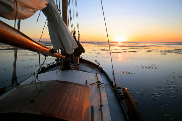 A sailboat lying on a sandbank during low tide