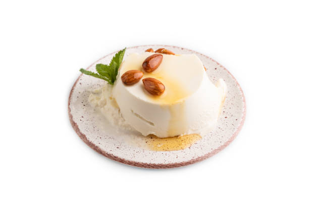 istock Ricotta cheese with honey and almonds isolated on white. side view, close up. 1446553609