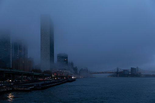 Fog over the buildings in midtown Manhattan and East River