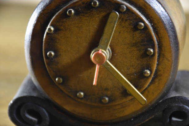 istock Close up of vintage leather alarm  clock on table 1446554813