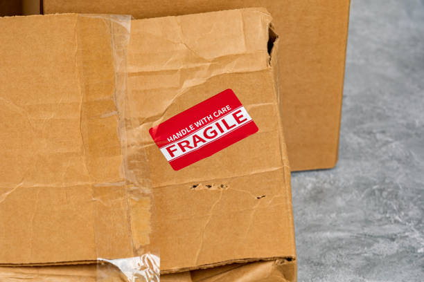 istock Damaged cardboard box with fragile label. Package insurance, mail delivery and shipping deadline concept 1446555585