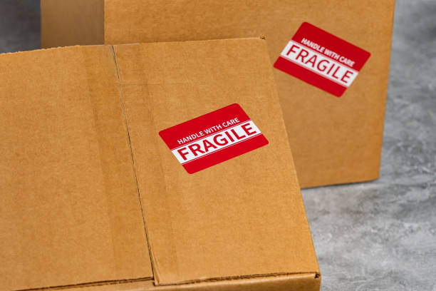 istock Cardboard box with fragile label. Package insurance, mail delivery and shipping deadline concept. 1446555592