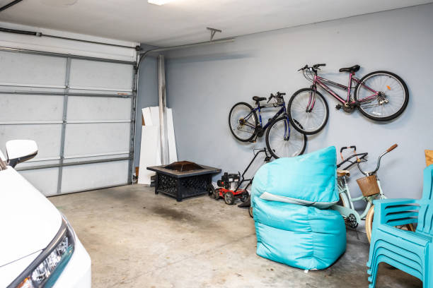 istock A two car garage with one white car parked and an empty space with bicycles hanging on the wall 1446556828