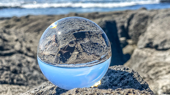 A crystal ball reflects the beauty of Hawaii’s coast. On a bright day the beauty of the tropical climate of Hawaii’s Big Island was stunning.