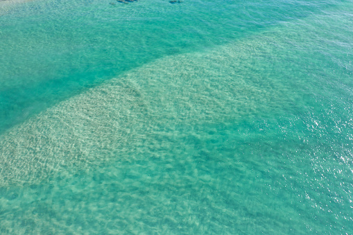 Aerial view of sand bar and depth of crystal clear blue water