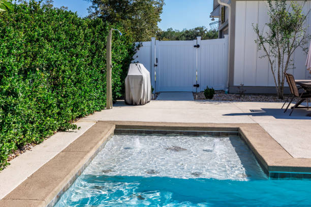 istock A rectangular new swimming pool with tan concrete edges in the fenced backyard of a new construction house 1446558049