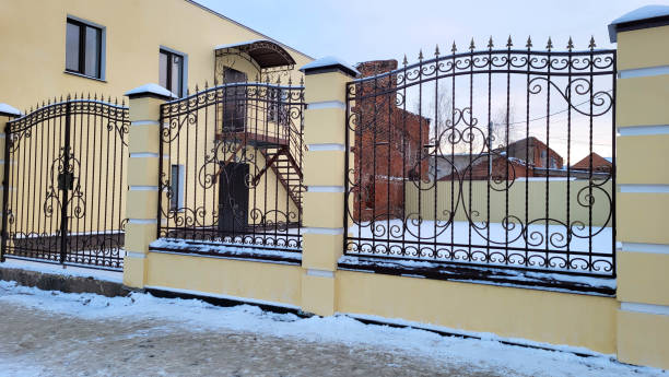 istock Metal fence grating with twisted decorations on a winter day 1446558751