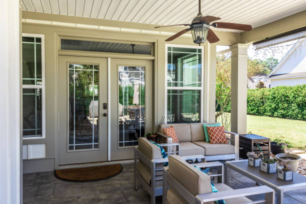 Covered outdoor patio in a new construction house home with guest seating. Covered outdoor patio in a new construction house home with guest seating. patio doors stock pictures, royalty-free photos & images