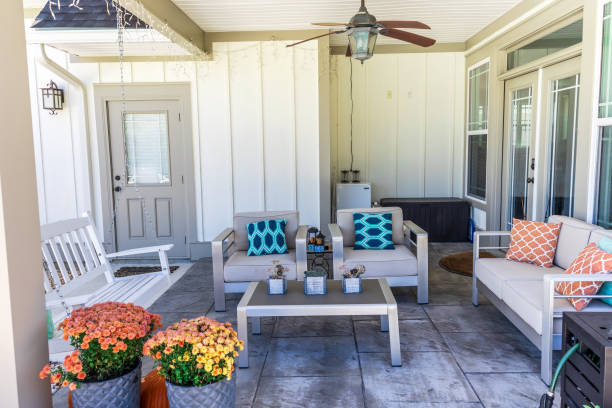 Covered outdoor patio in a new construction house home with guest seating Covered outdoor patio in a new construction house home with guest seating. patio cover stock pictures, royalty-free photos & images