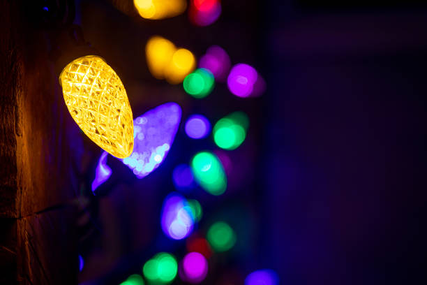 istock Colour christmas light hanging on wood stud home decoration 1446561712
