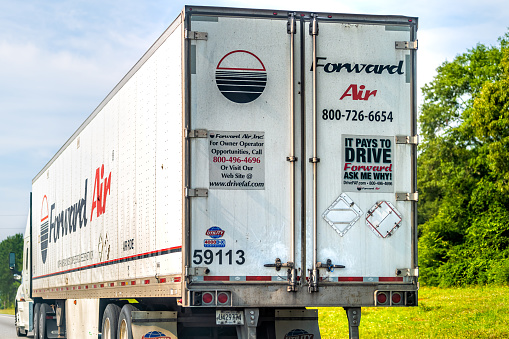 Marion, USA - July 6, 2021: Forward air refrigerated truck delivering cargo freight shipment on interstate highway road in North Carolina