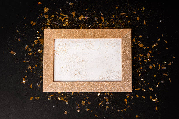 istock Gold frame from glitters on a black background. Greeting cards.Copy space.New Year's card background.Close-up. 1446571732
