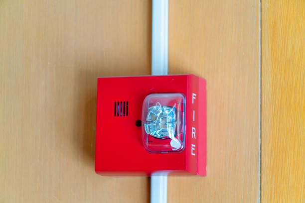 istock red fire alarm on wooden background indoors 1446575133