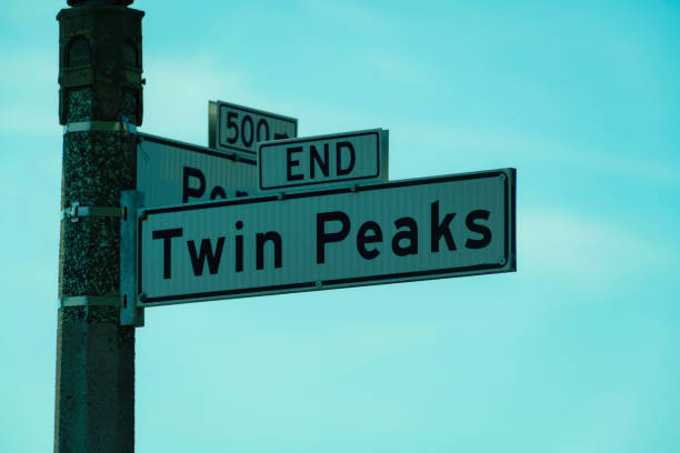 istock sign on light pole that says twin peaks on it with blue and white sky background 1446577170
