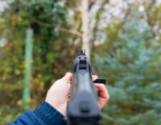 istock Hand holding Kalashnikov assault rifle first person view 1446578060