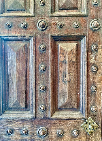 Vertical close up of old antique wood front door frame with metal design