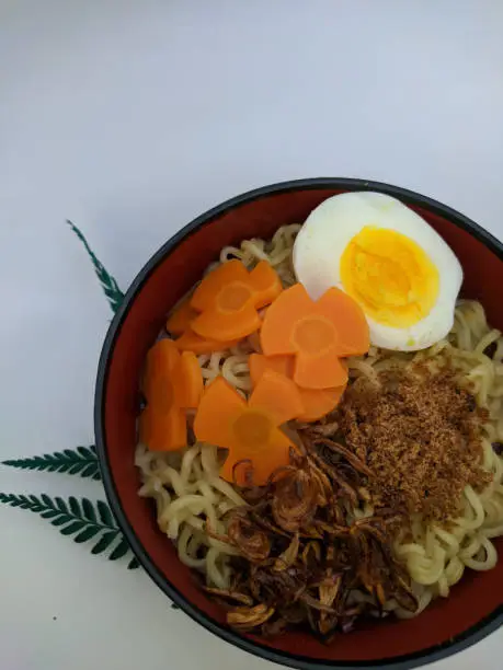 Photo of a beautiful bowl of noodles garnished with eggs and carrots