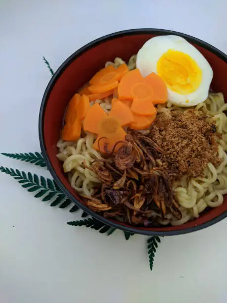 Photo of a bowl of noodles with some decorations on it to beautify the look