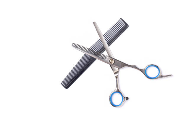 Scissors and hairbrush isolated on white background.