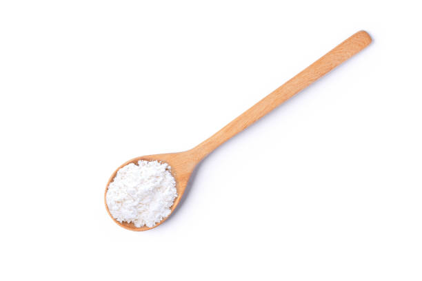 istock Calcium hydroxide powder (Dehydrated lime) in wooden spoon isolated on white background. 1446598006