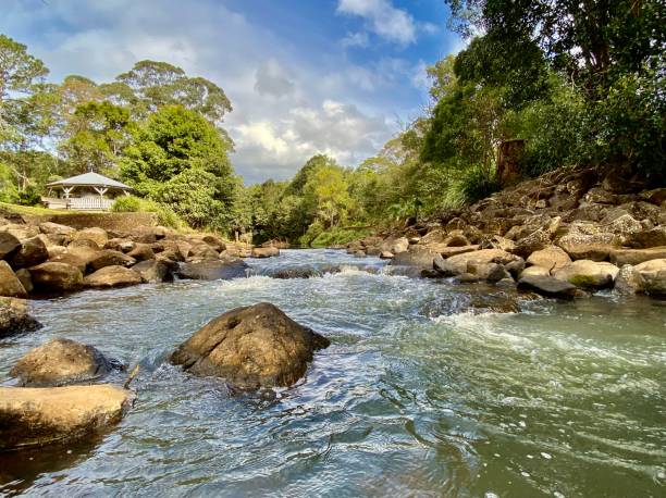 Water Flows Through River Rocks stock photo