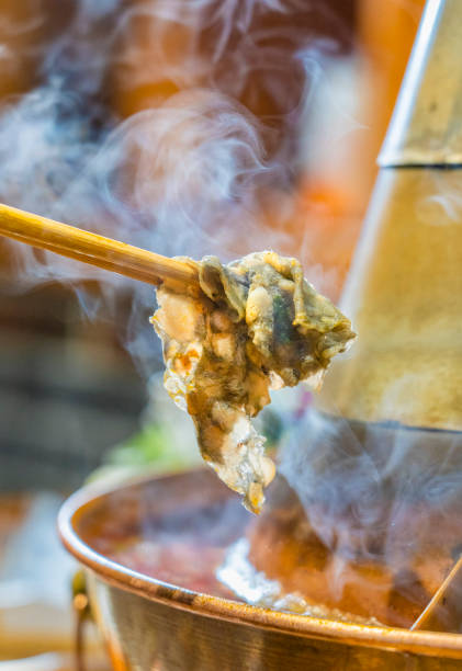 istock Chopsticks pick up the ingredients from the hotpot 1446602488