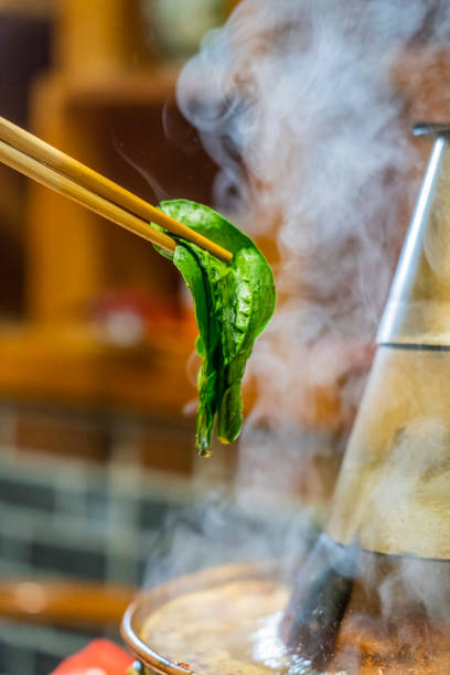 istock Chopsticks pick up the ingredients from the hotpot 1446602512