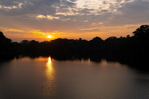 Sunrise reflection in the Amazon Rainforest.