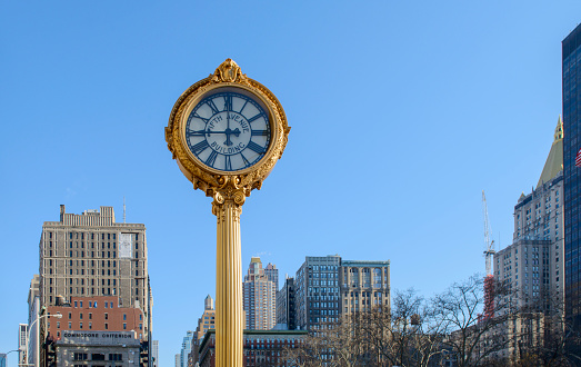 New York City, New York, USA - February 11, 2014: Street view of Fifth Ave Building Clock and New York City Midtown Manhattan buildings