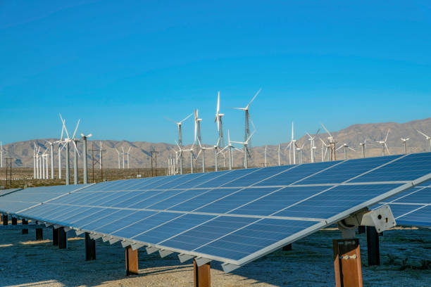 istock Windmills and solar panels with mountain and blue sky on a sunny day 1446613872
