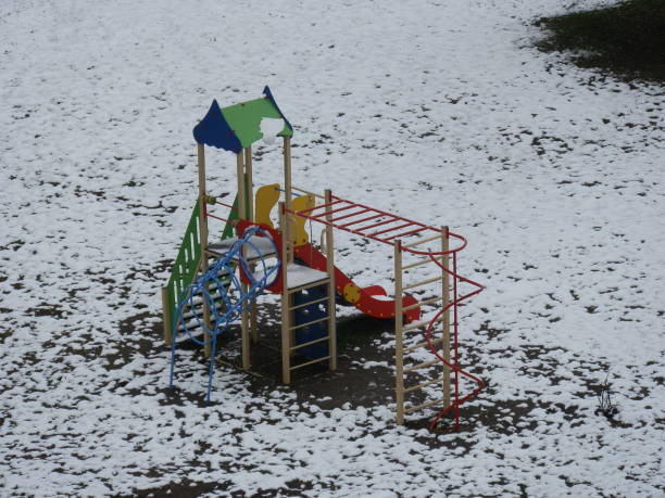 Children's playground in the snowy yard stock photo