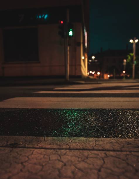 istock Closeup of zebra crossing lines at night 1446616196