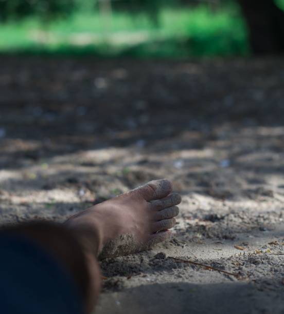 istock Closeup of a person's foot on a sandy surface in a park 1446616407