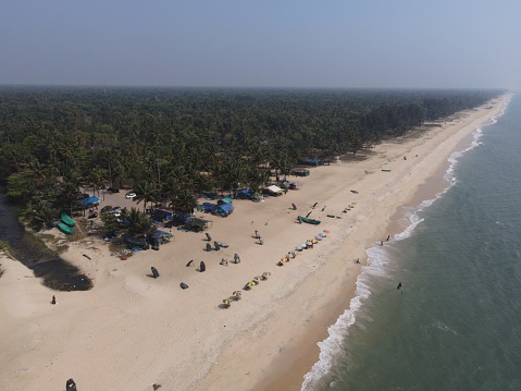 A aerial shot of waves washing up the shore Alleppey beach in India