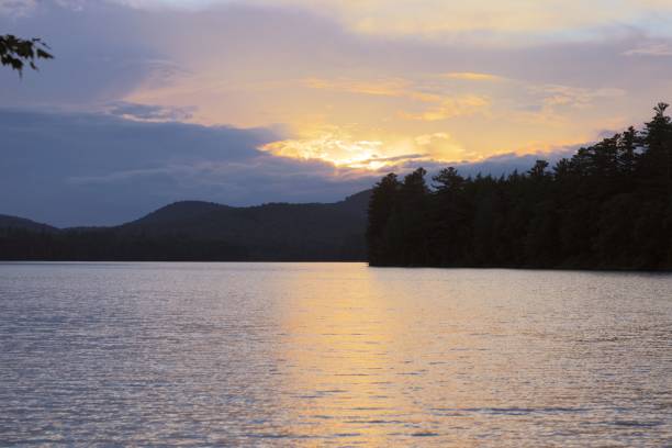 istock Silhouette of trees and mountains surrounded by water during sunset 1446617019
