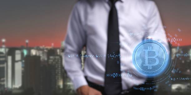 istock Person presenting a virtual projection of the cryptocurrency symbol 1446617058